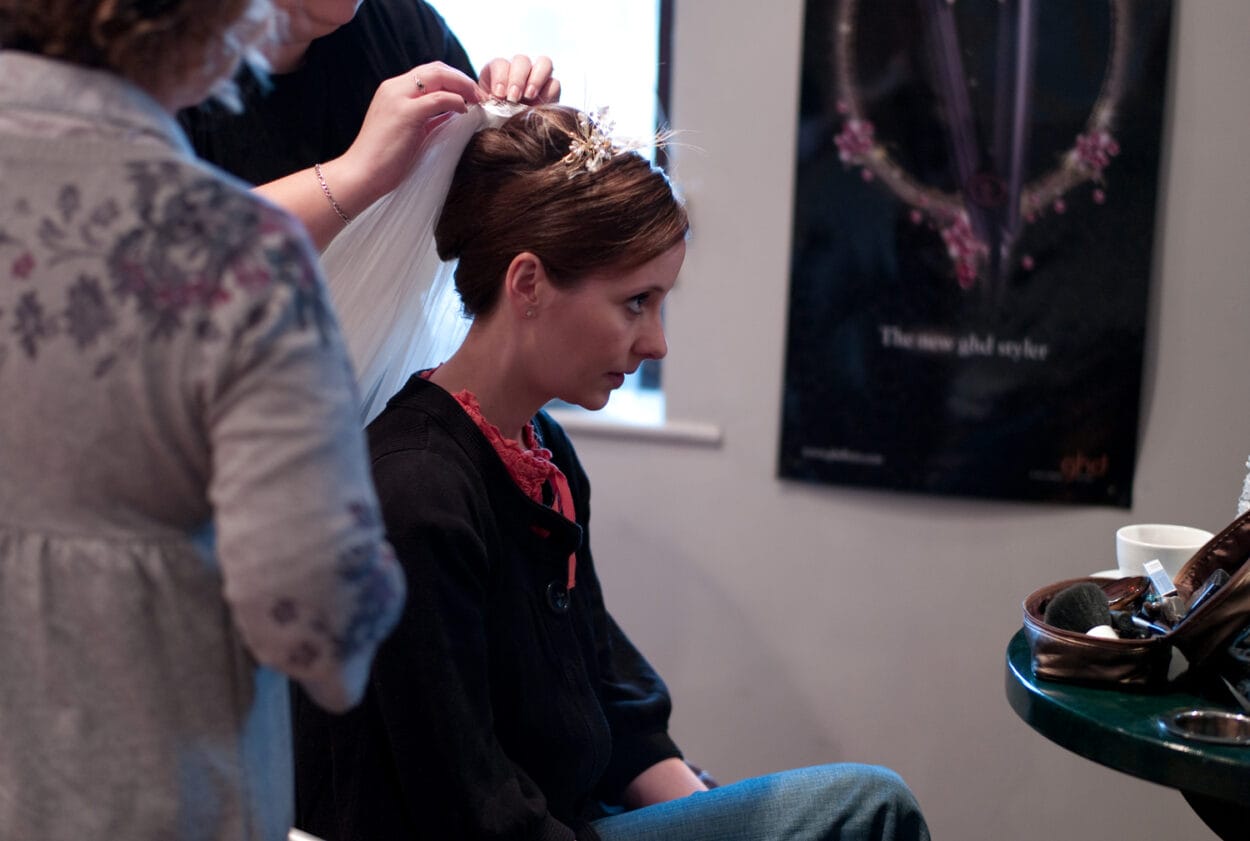 Emelie’s wedding veil being placed with careful concentration.