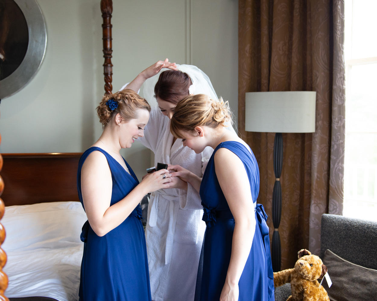 Bride and bridesmaids admire gifts during preparations