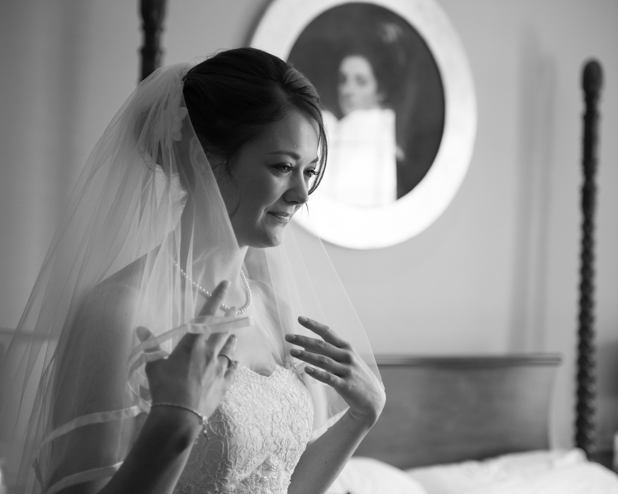 Bride Tanya touches the edge of her veil in monochrome