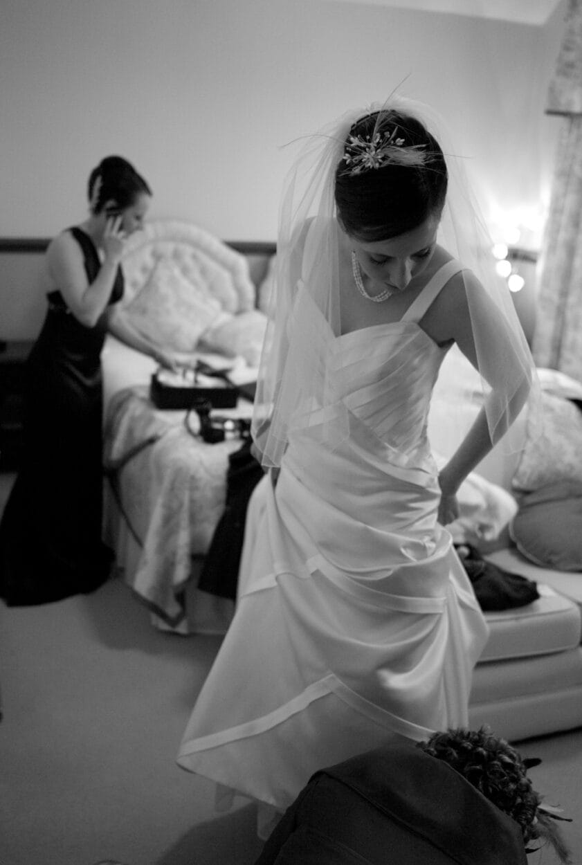 Mum kneels helping Emelie with her wedding shoes, captured in my Leeds wedding photographer documentary style.