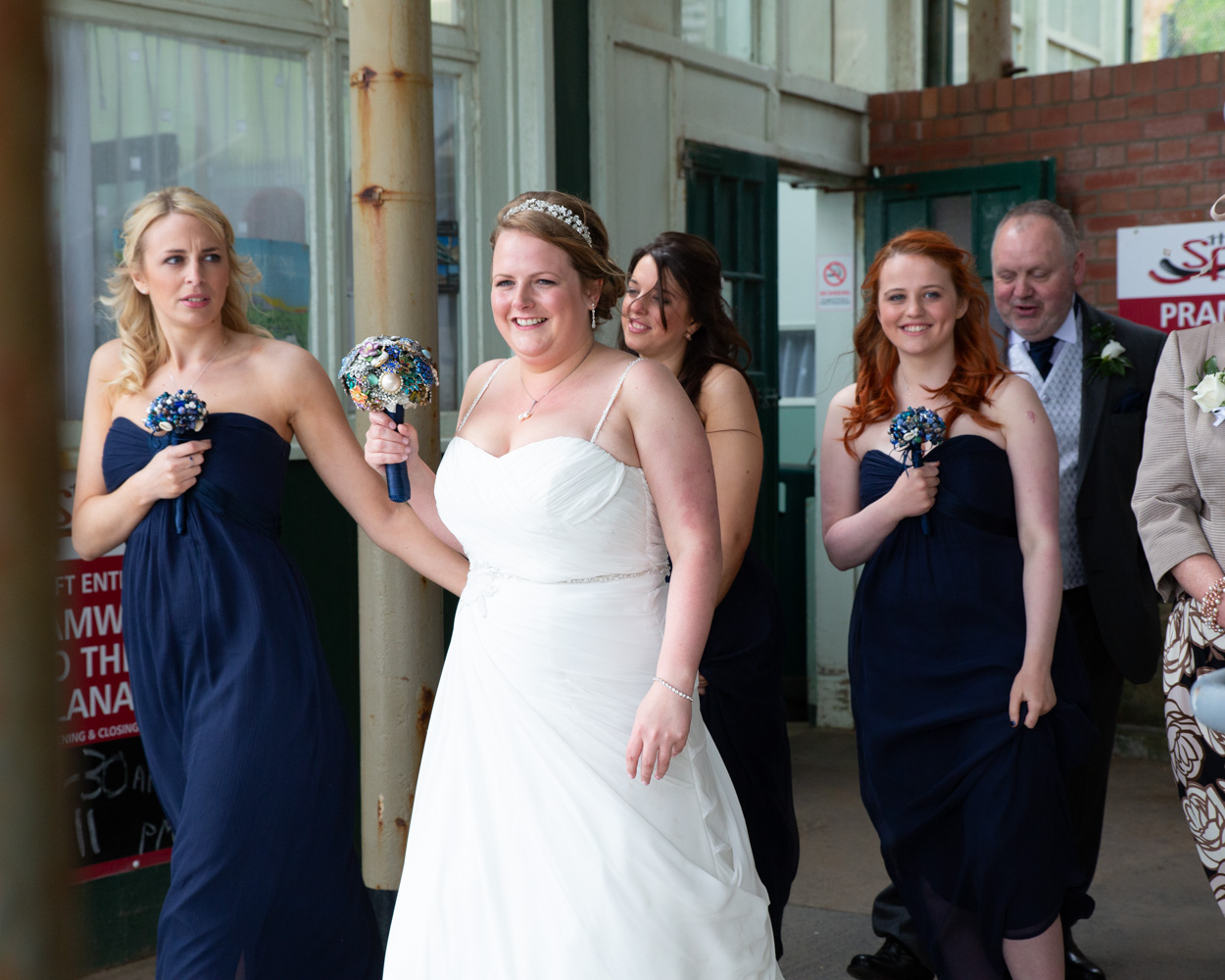 Candid wedding moments outside the Scarborough cliff lift, guests laughing and enjoying the atmosphere.