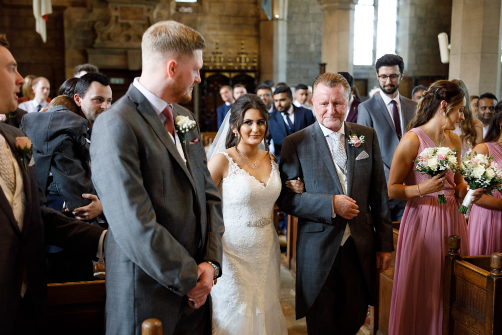 Bride and father reach the front of St Oswald’s Church; Kyra glances to Matt, seeking his approving smile.