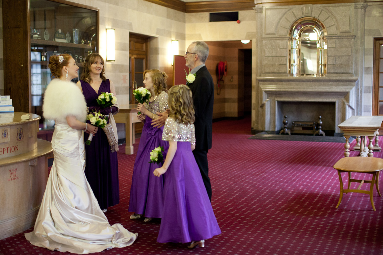 Father of the bride joining his daughter and bridesmaids before the ceremony.