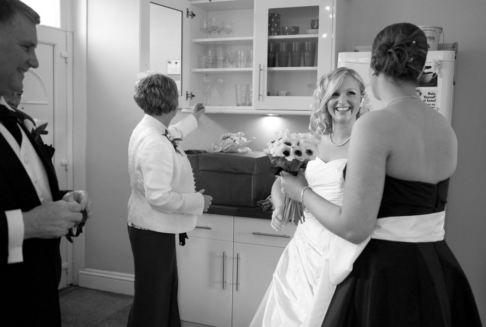 Second bridesmaid joins Dani in the kitchen, all smiles