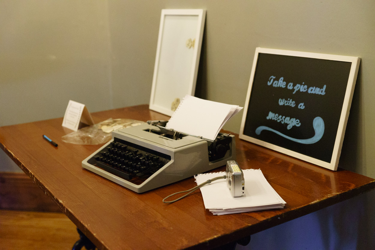 Typewriter guestbook station inviting messages for the couple