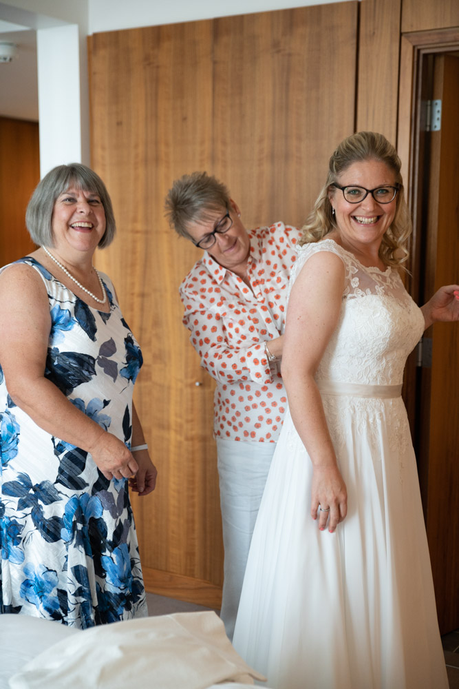 Family help Clare lace up her dress at DoubleTree by Hilton Leeds