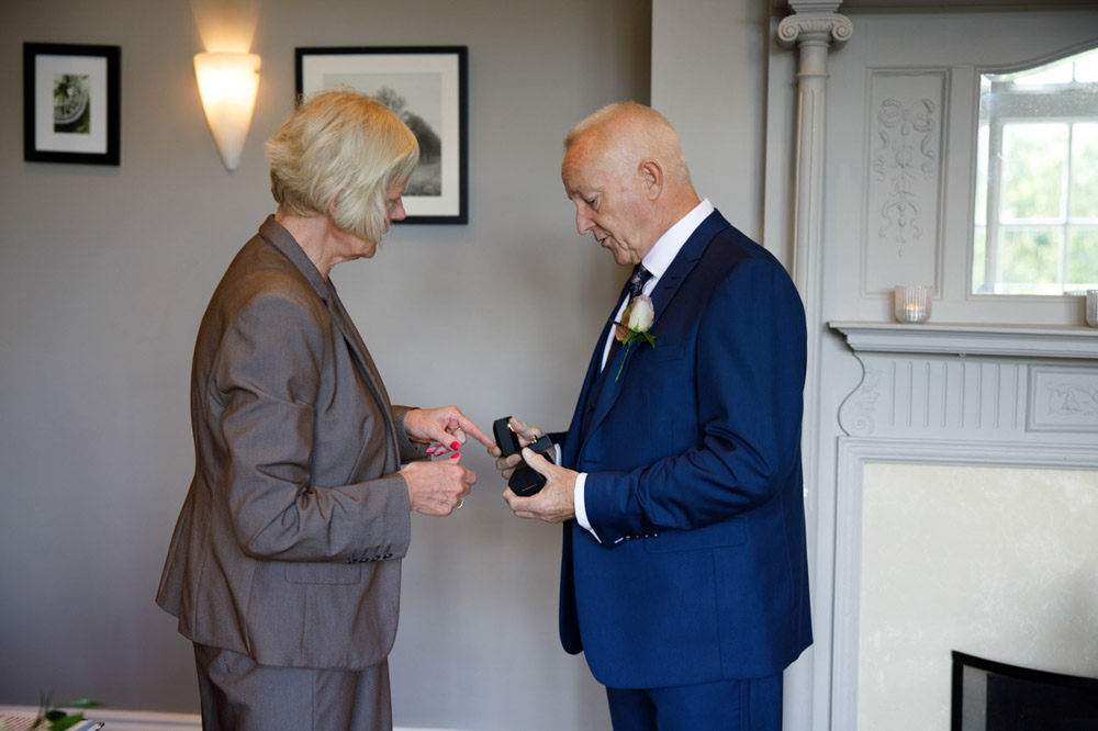Best man shows the wedding rings to the registrar before the ceremony begins