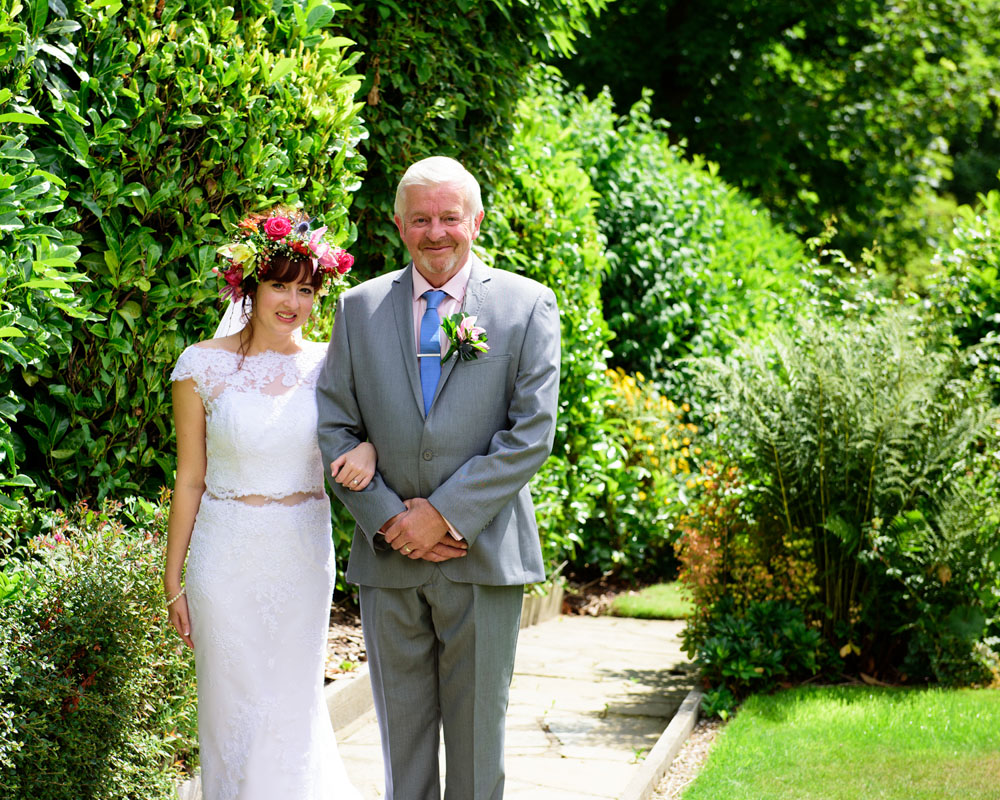 Bride and father in garden light before the ceremony — candid West Yorkshire wedding photography.