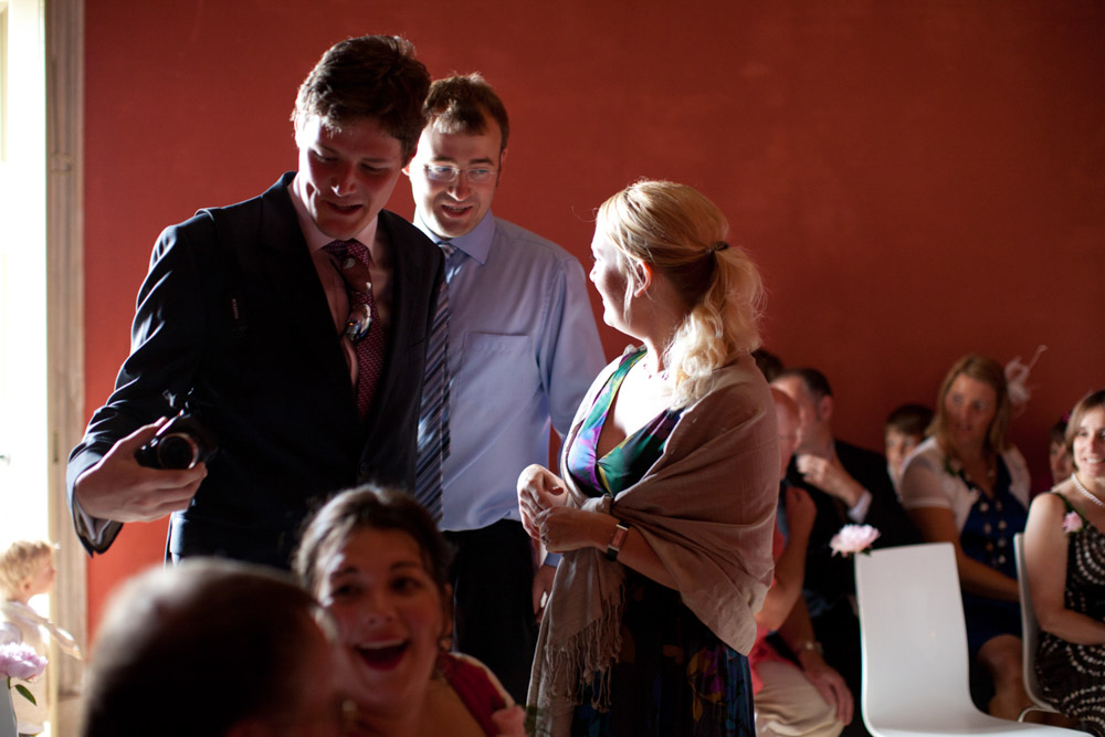 Wedding guests seated and chatting inside the Temple of Apollo before the ceremony