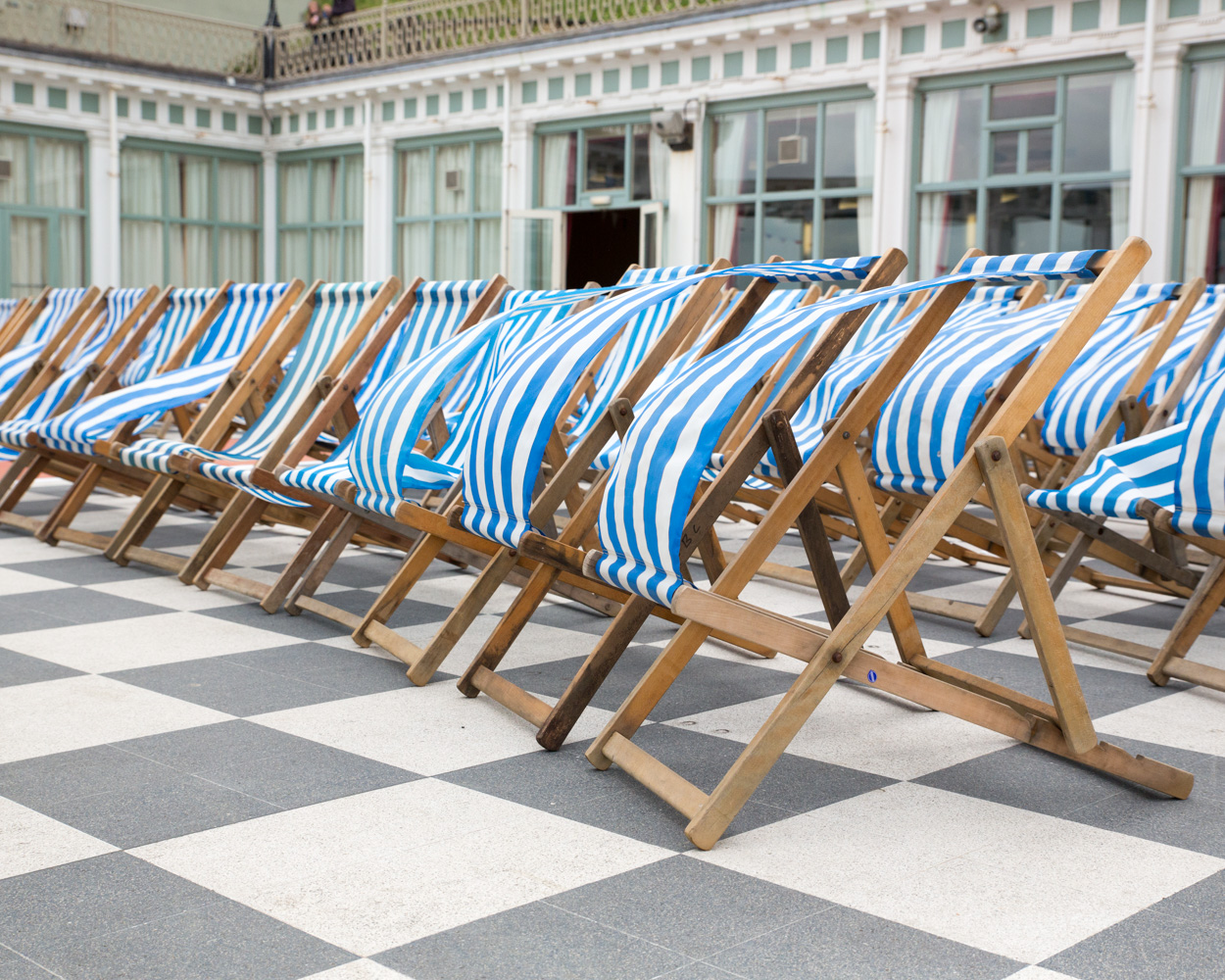 Rows of blue and white striped deck chairs outside Scarborough Spa, ready for a seaside wedding as the breeze moves through.