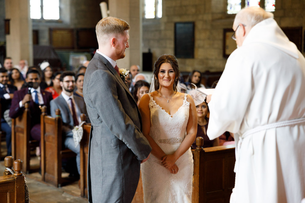 Kyra turns and smiles at the camera during the ceremony, full of joy and emotion.