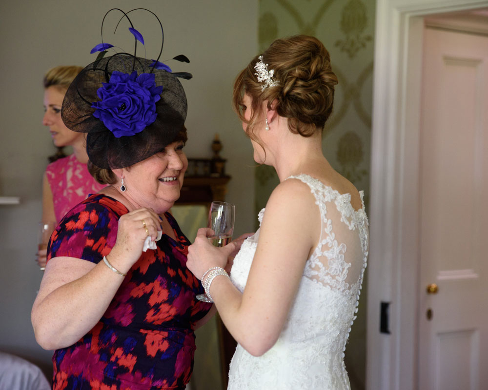 A good friend beams with happiness seeing Lisa in her dress.