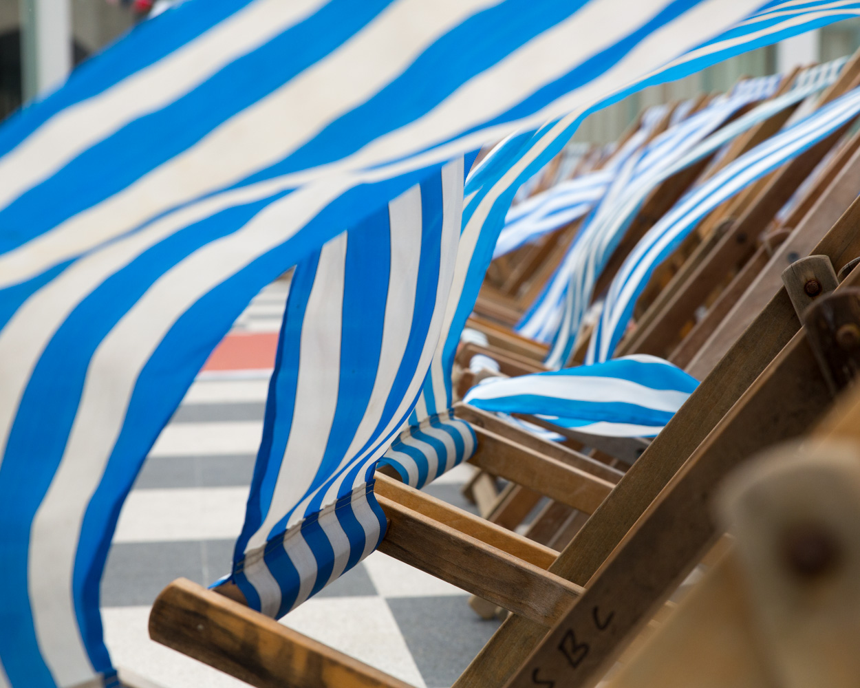 Close-up of a blue and white deck chair cloth blowing in the wind at a Scarborough Spa wedding.