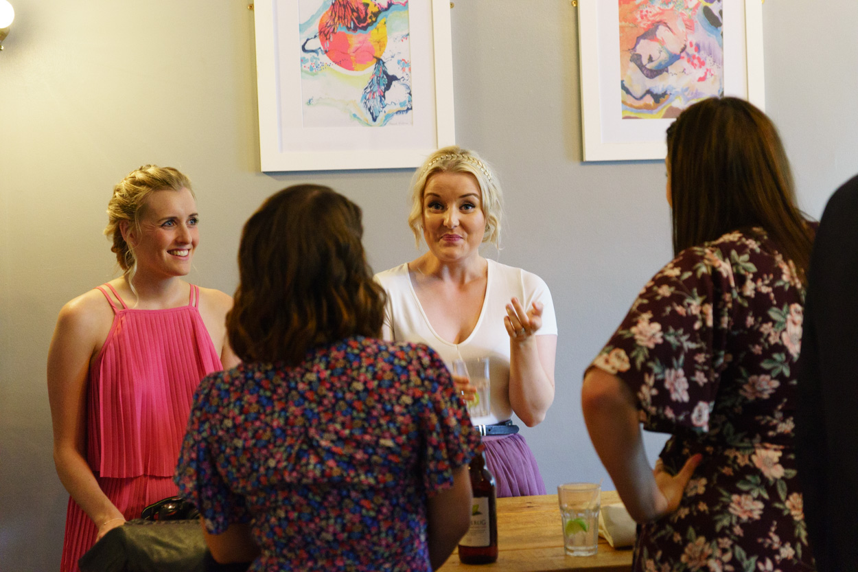 Guests chatting naturally during wedding drinks reception