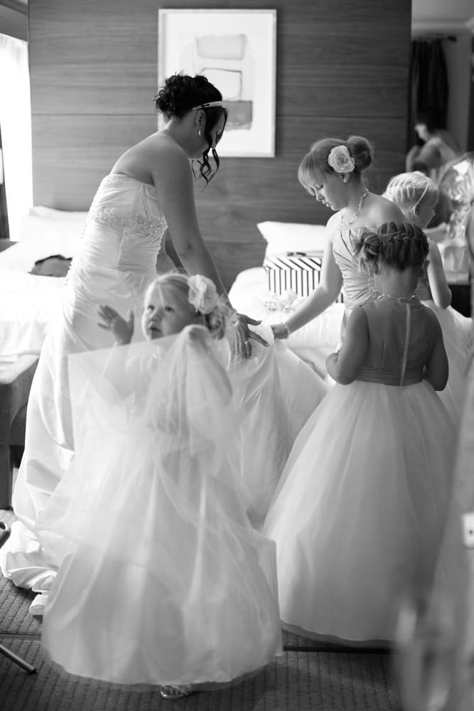 Gemma and her young bridesmaids stand together, fully ready in black and white.