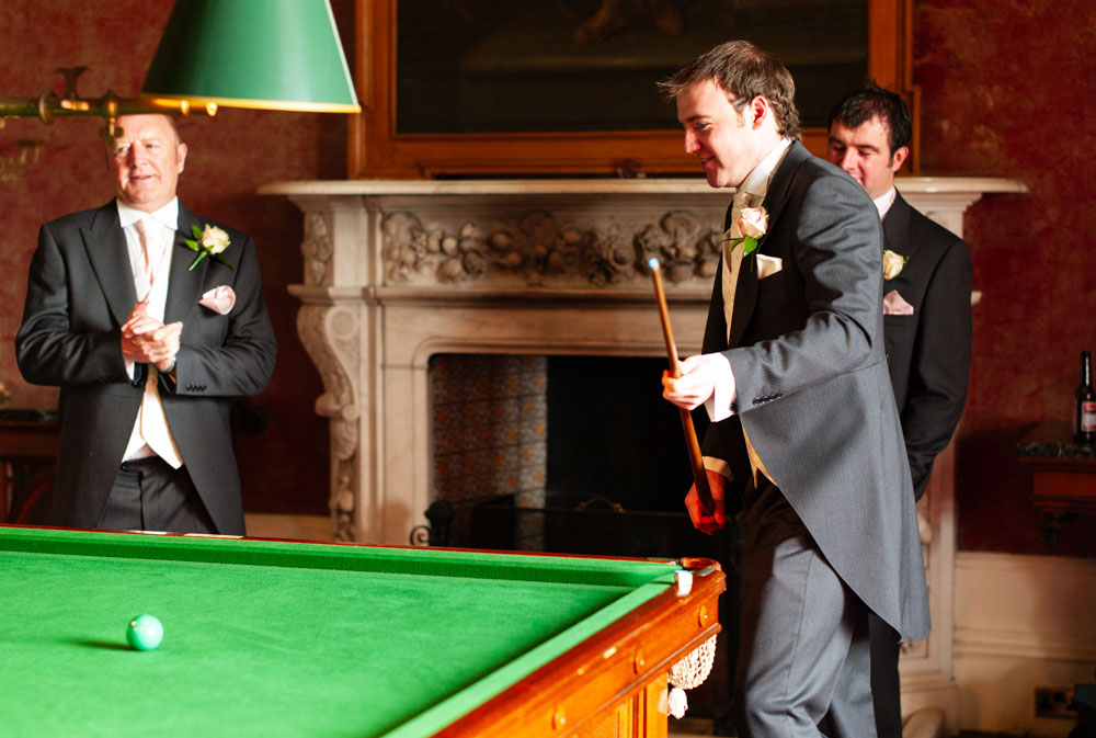 Groom plays snooker with groomsmen downstairs at Allerton Castle before the ceremony.