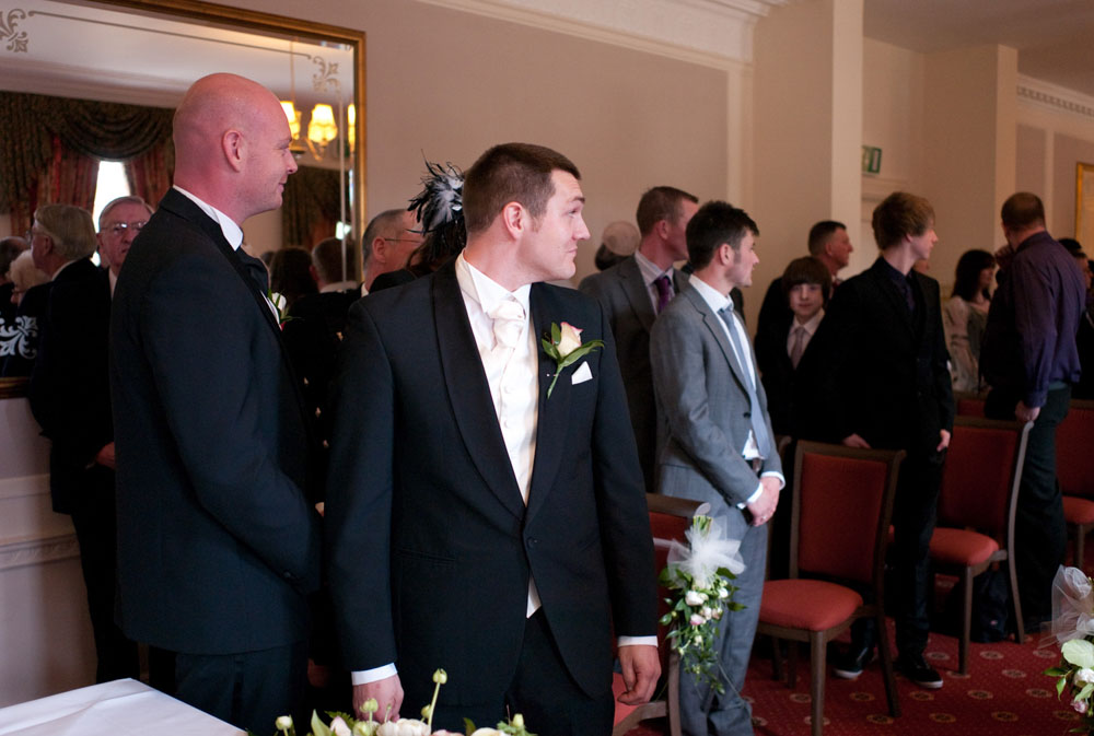 Scott and his best man standing as Dani enters
