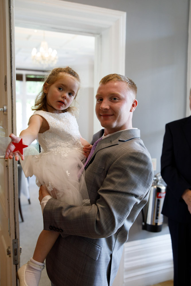 Father and daughter captured in a candid moment among guests