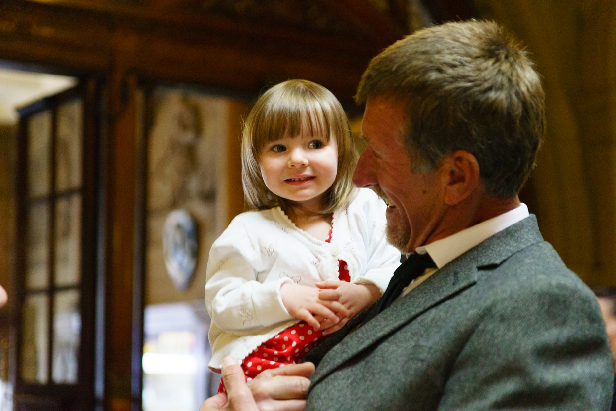 Grandfather holding a baby with a warm smile