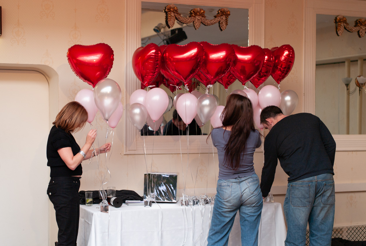 Helium heart and white balloons tied to gift boxes at Stirk House