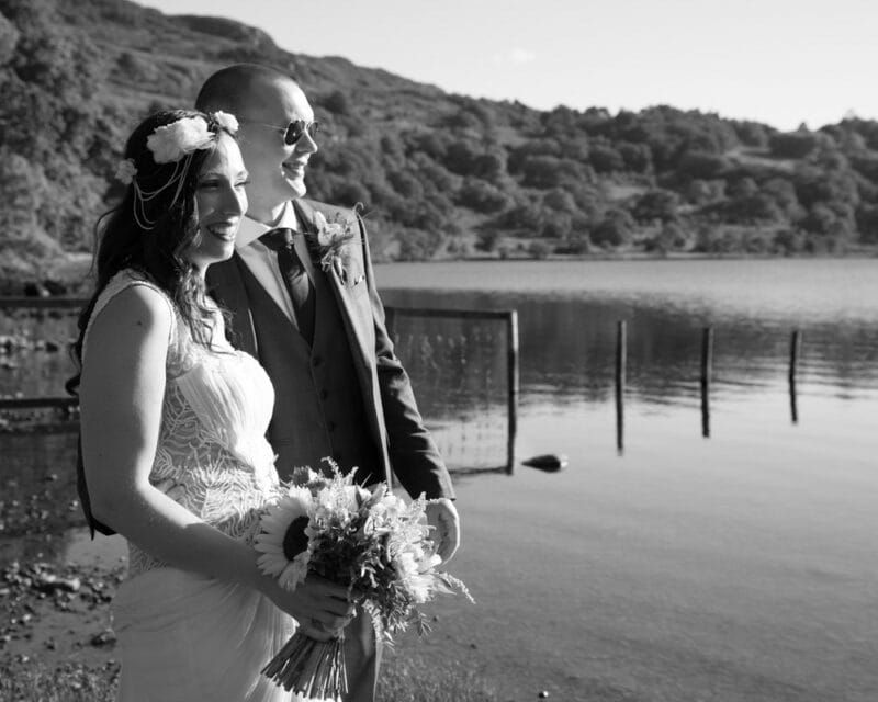 Wedding couple by the lake, smiling and enjoying golden hour light