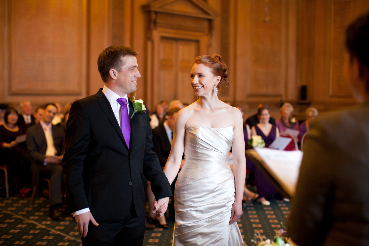 Bride and groom exchanging smiles as the ceremony formally begins.