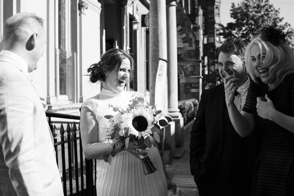 Leeds Civic Hall Wedding of Gemma & Danny - having departed the Civic Hall - arriving at the Lost 7 Found Leeds Club - Gemma the bride in fits of laughter with her new sister in law et.al.
