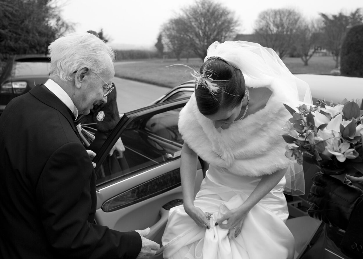 The bride arrives as her 94-year-old grandad watches proudly.