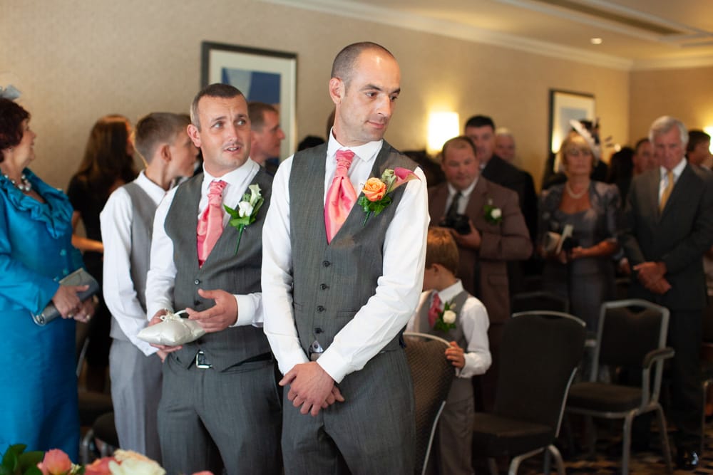 The bride’s arrival is announced as Dave looks back, anticipation written on his face.