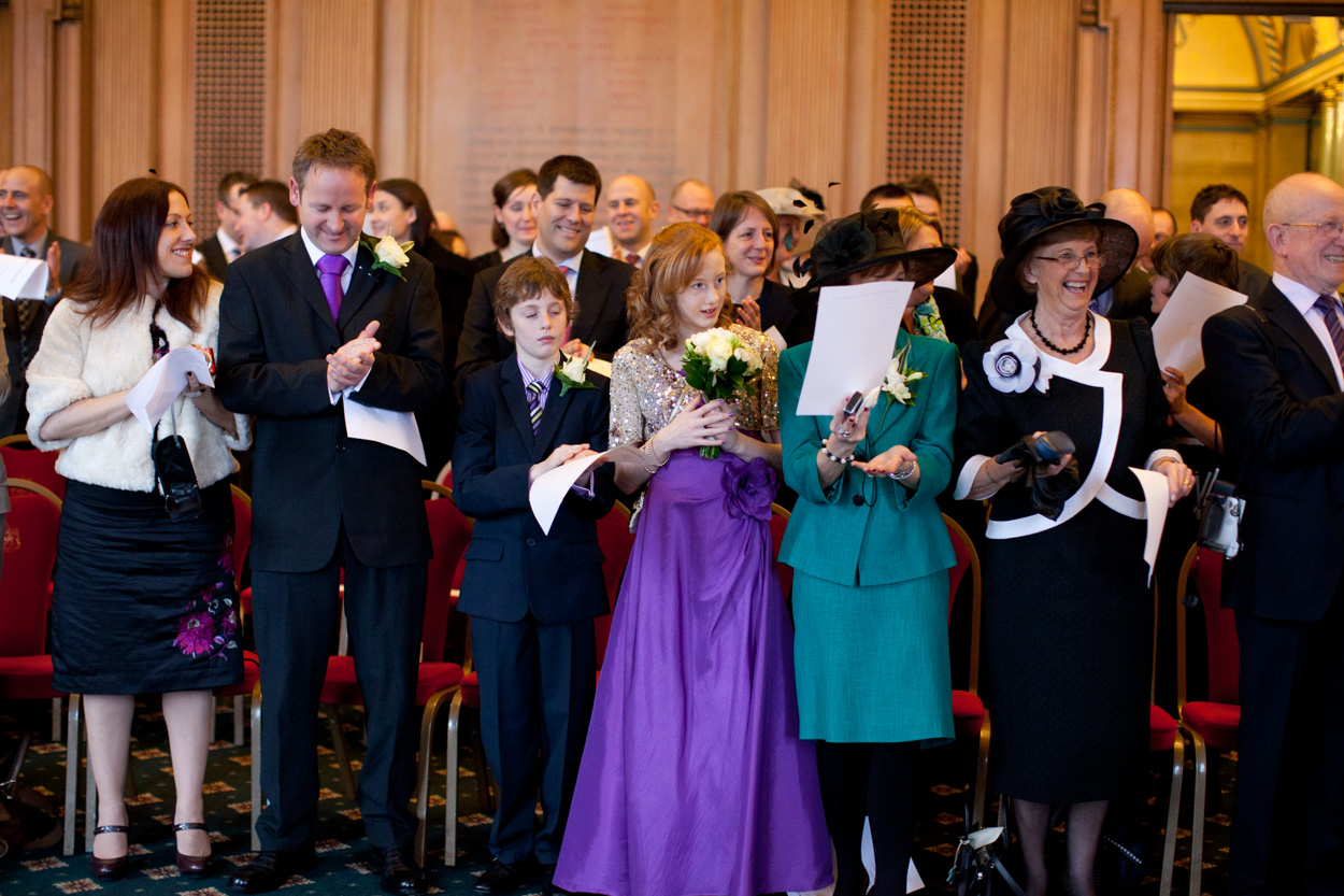 Guests standing to sing together during the ceremony at Leeds Civic Hall.
