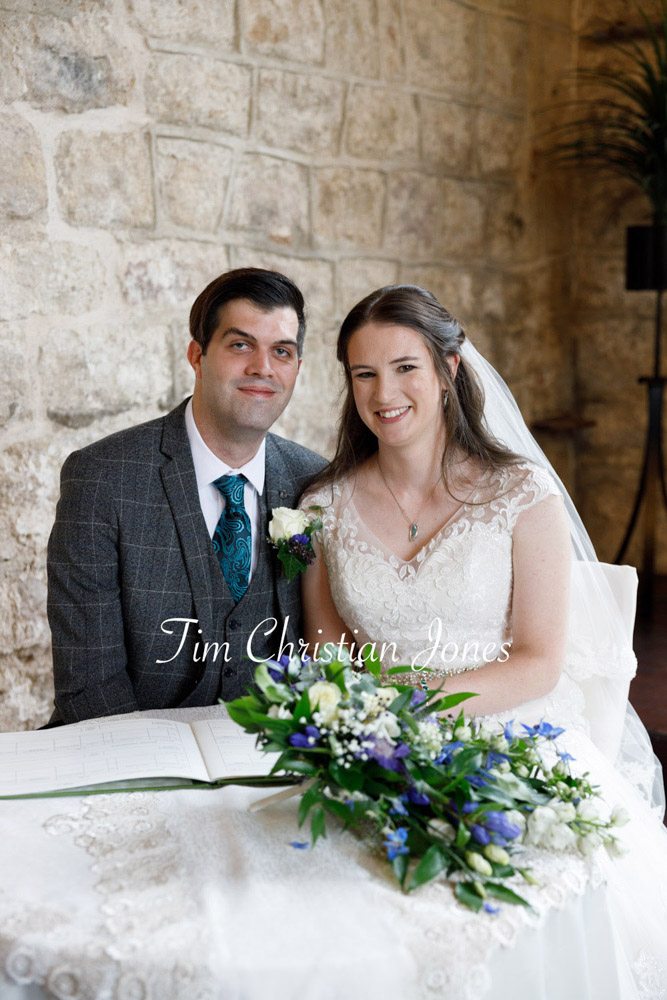 022 couple smiling for camera wedding register table jc