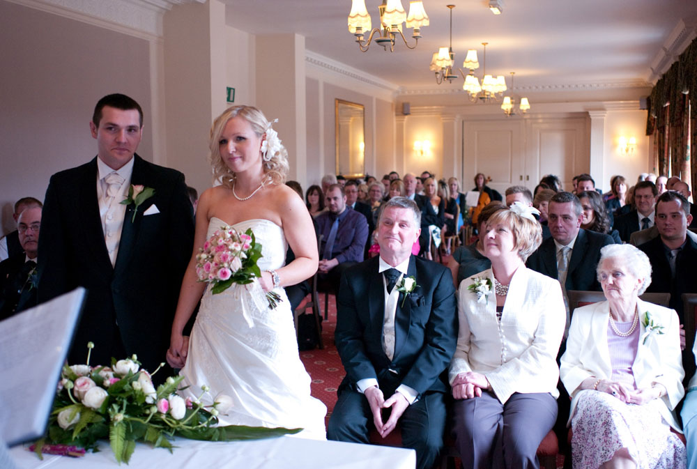 Dani and Scott seated as ceremony continues