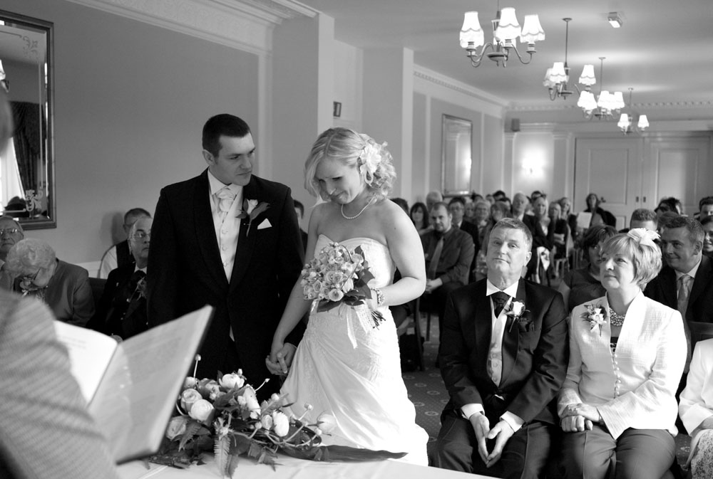 Dani holds back tears during the vows, black and white photo