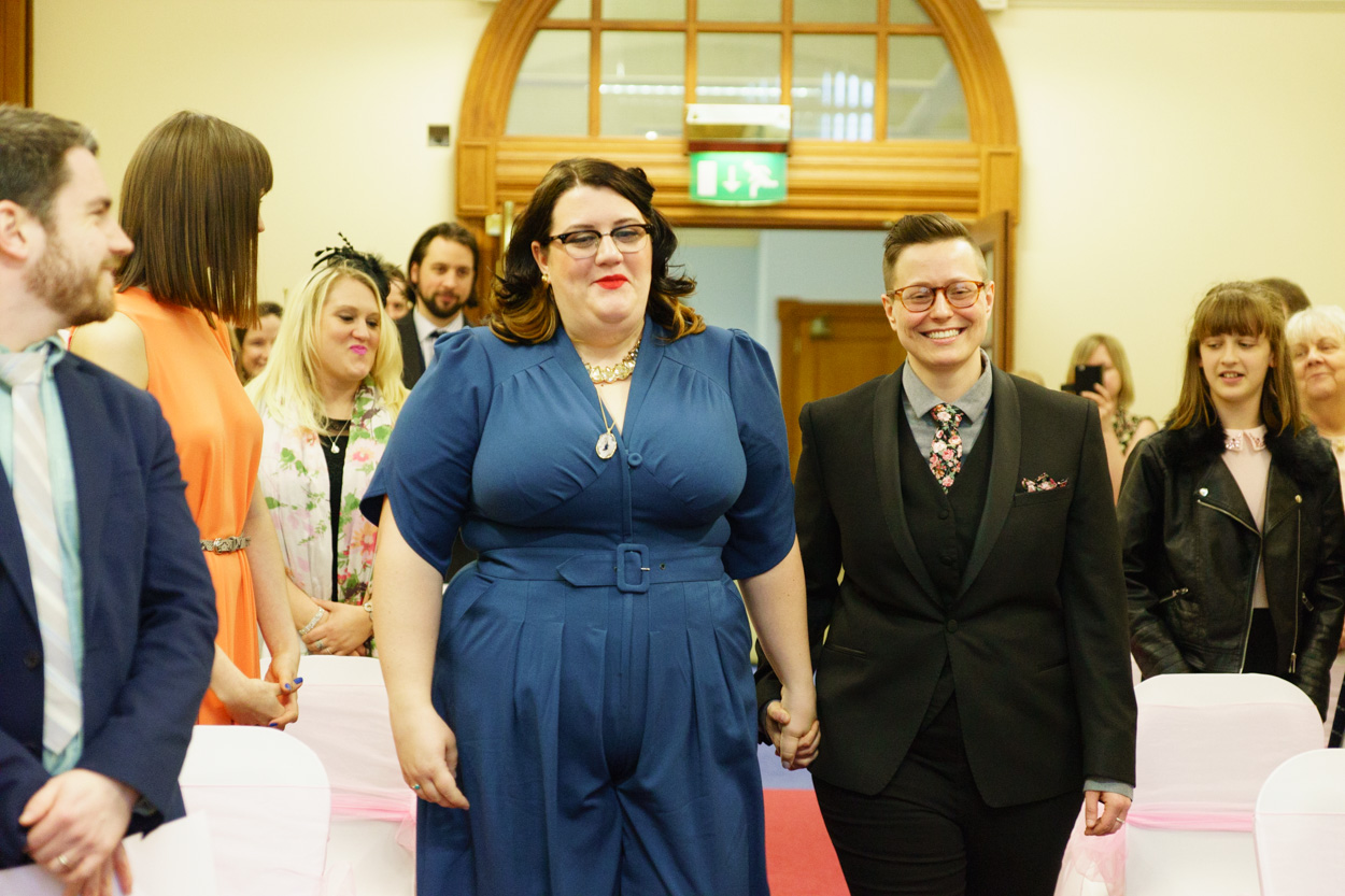 Couple continuing their aisle walk smiling