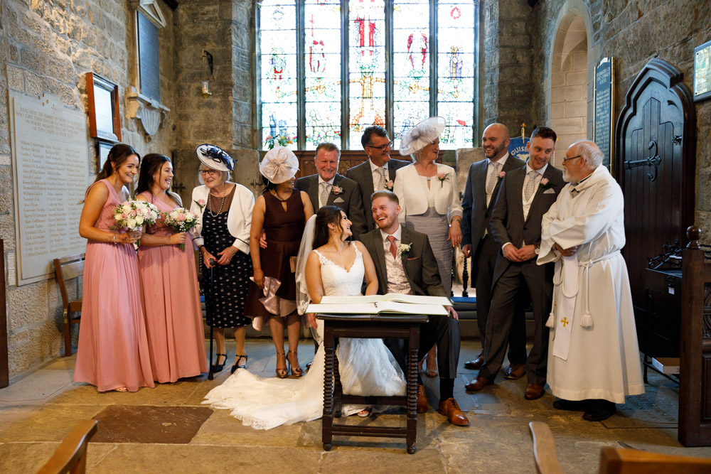 The wedding party relaxed and smiling, a group portrait filled with character and warmth.
