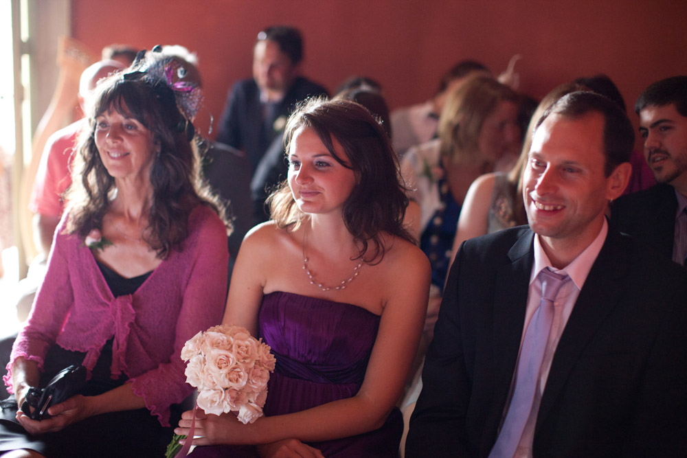 Guests seated in the front row smiling during the ceremony