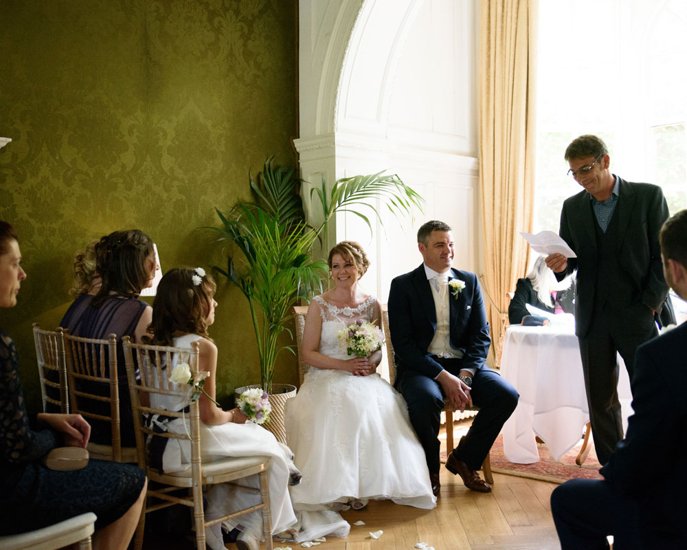Wide shot of the reading moment in soft, natural light and pastel colours.