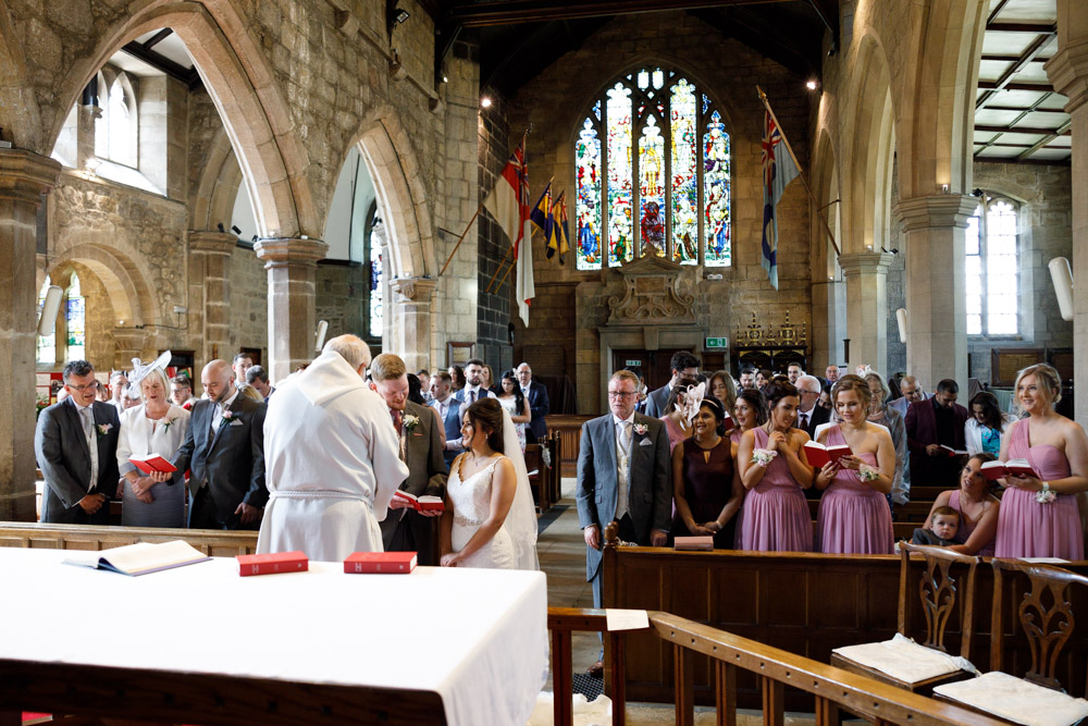 A wide view of St Oswald’s Church filled with music and light as everyone sings.
