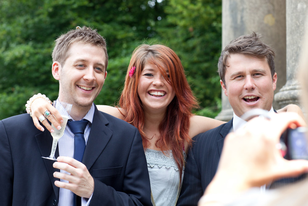 Natural group photos taking place casually among wedding guests