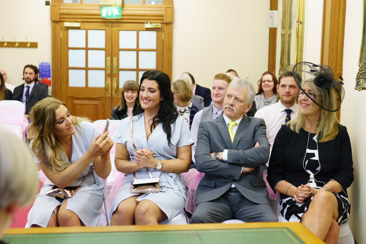 Lizzie’s sister photographing her mum smiling in the front row