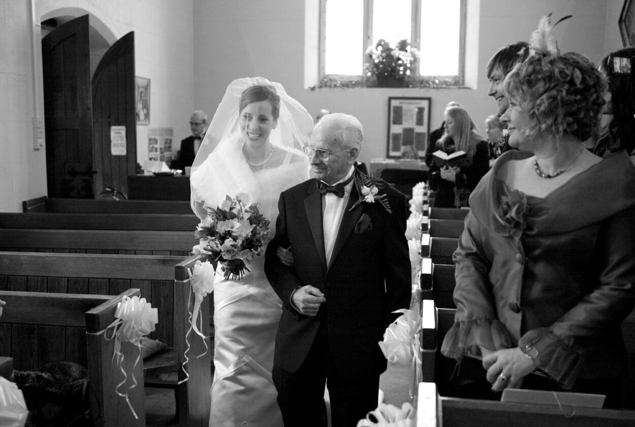 Joyful faces fill the aisle as Emelie walks towards Matt.