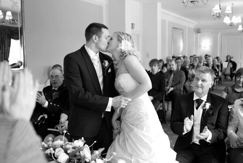 Dani and Scott share their first kiss, black and white photo
