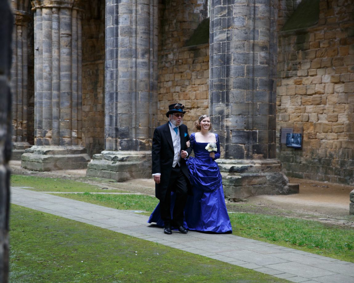 029 the bride smiles as they near the end kirkstall abbey wedding linsey and chris