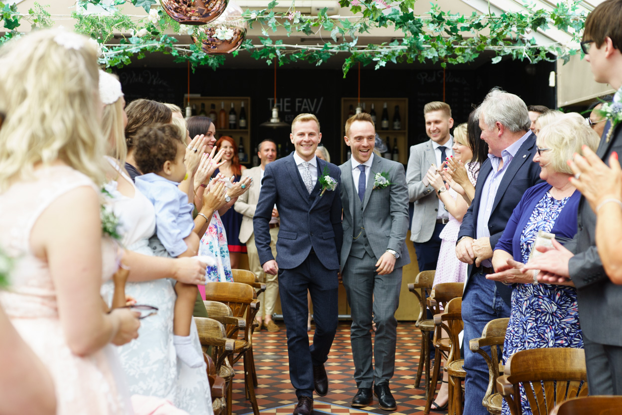 Applause as the couple walk down the aisle