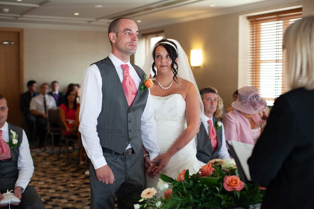 Emotional groom holding hands with Gemma as guests wait quietly for the ceremony to begin.