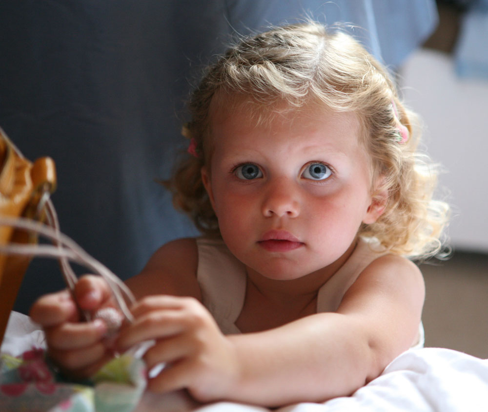 Bride’s daughter bathed in gentle natural light during wedding preparations