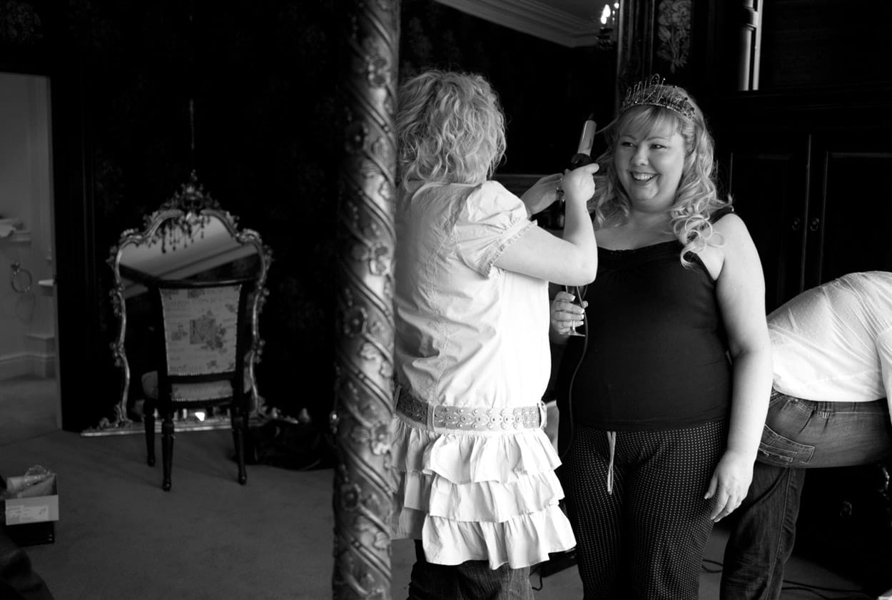 Black and white portrait of Nikki smiling after her hair is finished.