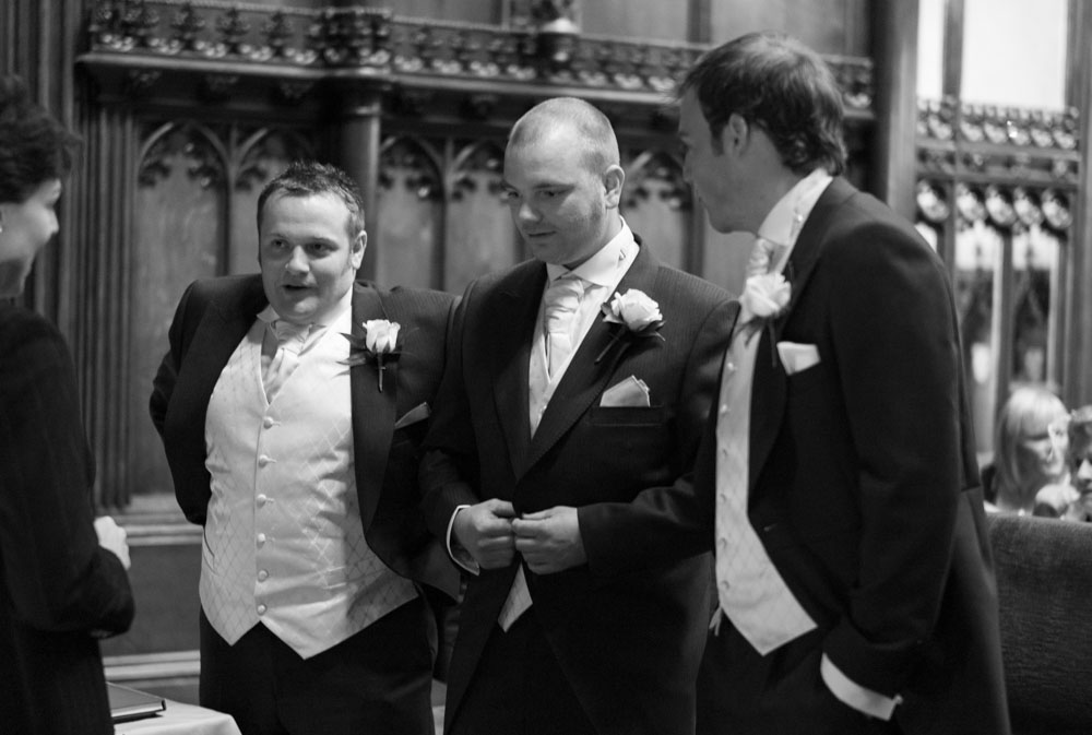 Groom and his two best men adjusting jackets and chatting with the registrar at Allerton Castle.