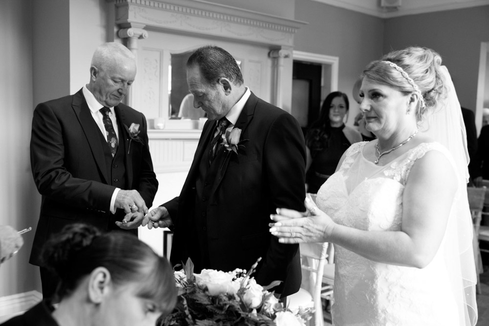 Best man hands Tracy’s wedding ring to Gary during the ceremony