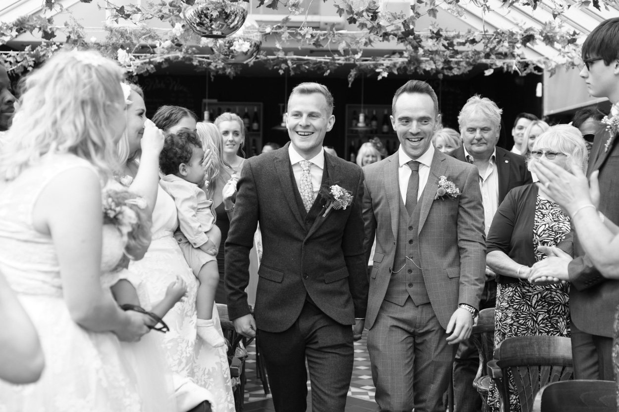 Wedding aisle walk captured in black and white